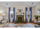Cozy living room with a fireplace and large windows offering lots of natural light at 121 Yorkshire Dr, Salisbury, NC 28144