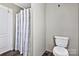 Bathroom featuring a toilet and shower area with a simple striped curtain at 1317 Liberty Rd, Chester, SC 29706