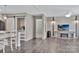 Open-concept living room features modern flooring, a sliding barn door, and a decorative accent wall with a television at 1317 Liberty Rd, Chester, SC 29706