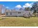 Rear exterior of a home with a small deck, well-kept lawn, and storage at 1317 Liberty Rd, Chester, SC 29706