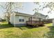 View of the home's back exterior with a deck and patio, surrounded by lawn at 134 Chere Helen Dr, Mooresville, NC 28115