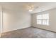 Carpeted bedroom featuring a ceiling fan and a large window at 134 Chere Helen Dr, Mooresville, NC 28115