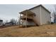 Exterior view of the home's backyard featuring a wooden deck and stairs at 145 High Rock Ct # 03, Statesville, NC 28677