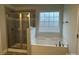 Bathroom featuring a soaking tub and glass shower enclosure at 145 High Rock Ct # 03, Statesville, NC 28677