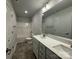 Modern bathroom with double vanity, quartz countertop, and tub-shower combo at 145 High Rock Ct # 03, Statesville, NC 28677