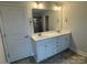 Bathroom showcasing a double sink vanity and a large mirror at 145 High Rock Ct # 03, Statesville, NC 28677