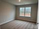 Bright bedroom with neutral carpet, paint, and large window for natural light at 145 High Rock Ct # 03, Statesville, NC 28677