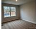 Cozy bedroom with neutral carpet, paint, and large window for natural light at 145 High Rock Ct # 03, Statesville, NC 28677