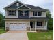Charming two-story home featuring a covered porch, two-car garage, and beautiful contrasting siding at 145 High Rock Ct # 03, Statesville, NC 28677