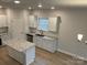 This open concept kitchen features an island, granite countertops and modern fixtures at 145 High Rock Ct # 03, Statesville, NC 28677