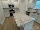 Contemporary kitchen with a granite island, stainless steel appliances, and ample counter space for cooking at 145 High Rock Ct # 03, Statesville, NC 28677