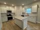 Well-lit kitchen with granite countertops, stainless steel appliances, and white cabinetry for a clean aesthetic at 145 High Rock Ct # 03, Statesville, NC 28677