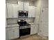 This kitchen features white cabinets, stainless steel appliances, and granite countertops at 145 High Rock Ct # 03, Statesville, NC 28677