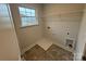 Functional laundry room with utility sink, shelving, and window for natural light at 145 High Rock Ct # 03, Statesville, NC 28677