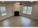 Bright and airy living room featuring a fireplace, hardwood floors, and large windows for natural light at 145 High Rock Ct # 03, Statesville, NC 28677