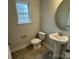 Compact half-bathroom with pedestal sink and window for natural light at 145 High Rock Ct # 03, Statesville, NC 28677