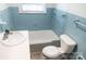 Bathroom with blue tile, a tub-shower, wood look flooring, and modern toilet at 1606 Mt Gallant Rd, Rock Hill, SC 29732