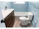 Bright bathroom featuring classic blue tile, a tub-shower, and a modern toilet at 1606 Mt Gallant Rd, Rock Hill, SC 29732