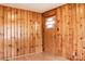 Bedroom with wood-paneled walls, laminate flooring, and a door leading to another room at 1606 Mt Gallant Rd, Rock Hill, SC 29732