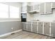 Well-lit kitchen with gray cabinets, white countertops, and wood-look flooring at 1606 Mt Gallant Rd, Rock Hill, SC 29732