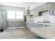 Kitchen featuring white cabinets, countertops, and wood-look flooring at 1606 Mt Gallant Rd, Rock Hill, SC 29732