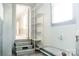 A charming laundry area with three steps and white shelving offers great storage at 1606 Mt Gallant Rd, Rock Hill, SC 29732
