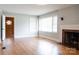Bright living room with hardwood floors, a decorative fireplace, and built-in shelving at 1606 Mt Gallant Rd, Rock Hill, SC 29732