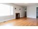 Inviting living room with hardwood floors, a classic fireplace, and ample natural light at 1606 Mt Gallant Rd, Rock Hill, SC 29732