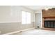 Cozy living room with brick fireplace, white trim and gray walls, and a ceiling fan at 1606 Mt Gallant Rd, Rock Hill, SC 29732