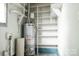 This storage space includes a water heater and lots of white shelving at 1606 Mt Gallant Rd, Rock Hill, SC 29732