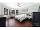 Spacious bedroom with hardwood flooring, a ceiling fan, and natural light from large windows at 16115 Chiltern Ln, Huntersville, NC 28078
