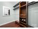 Well-organized walk-in closet featuring built-in shelving, drawers, and a full-length mirror at 16115 Chiltern Ln, Huntersville, NC 28078