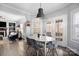 Inviting dining area featuring a modern chandelier, ample natural light, and hardwood floors at 16115 Chiltern Ln, Huntersville, NC 28078