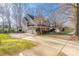 A lovely exterior view displaying the home with a three-car garage and a wide driveway at 16115 Chiltern Ln, Huntersville, NC 28078