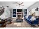 Cozy living room with a fireplace, built-in bookshelves, and comfortable seating at 16115 Chiltern Ln, Huntersville, NC 28078