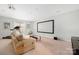 Spacious entertainment room featuring a large movie screen, comfortable sofa, and exercise equipment at 16115 Chiltern Ln, Huntersville, NC 28078