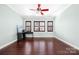 Bright office space with hardwood floors, a corner desk, and ample natural light from three windows at 16115 Chiltern Ln, Huntersville, NC 28078