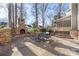 Outdoor patio with a brick fireplace and seating, ideal for entertaining guests or enjoying a quiet evening at 16115 Chiltern Ln, Huntersville, NC 28078