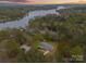Stunning aerial view of lakefront home surrounded by lush trees and serene waters at 1614 Fieldbrook Rd, Rock Hill, SC 29732