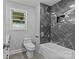 Modern bathroom with marble-look tile shower and tub combo, toilet, and light gray walls at 1614 Fieldbrook Rd, Rock Hill, SC 29732