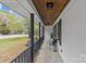 Charming front porch featuring black railings, stone flooring and a wood ceiling at 1614 Fieldbrook Rd, Rock Hill, SC 29732