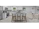 Bright open concept kitchen with white cabinetry, modern countertops and seating at the center island at 1614 Fieldbrook Rd, Rock Hill, SC 29732