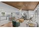 Open-concept living room with hardwood floors, wood ceiling, and a seamless connection to the kitchen and dining area at 1614 Fieldbrook Rd, Rock Hill, SC 29732
