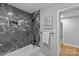 Updated shower and tub combo with dark tile surround, niche, and a shower head at 1614 Fieldbrook Rd, Rock Hill, SC 29732