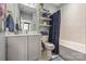 Well-designed bathroom showcasing a vanity, open shelves, and a bathtub-shower combination at 1727 Cannon View Ln, Charlotte, NC 28208