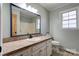 Classic bathroom featuring a white vanity, a large mirror, and neutral tile flooring at 200 South Fork Dr, Shelby, NC 28152