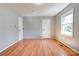 Minimalist bedroom with neutral walls, sleek wood floors, and natural light from the single window at 200 South Fork Dr, Shelby, NC 28152