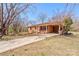 Charming brick home featuring a covered carport and a long driveway, nestled on a tree-filled lot at 200 South Fork Dr, Shelby, NC 28152