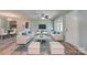 Bright living room featuring neutral decor, contemporary furnishings, light wood flooring, and a ceiling fan at 200 South Fork Dr, Shelby, NC 28152