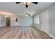 Open living area with light walls, wood floors, ceiling fans, and bright natural light from the large windows at 200 South Fork Dr, Shelby, NC 28152